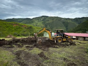 Excavation with backhoe for bamboo pavilion foundation