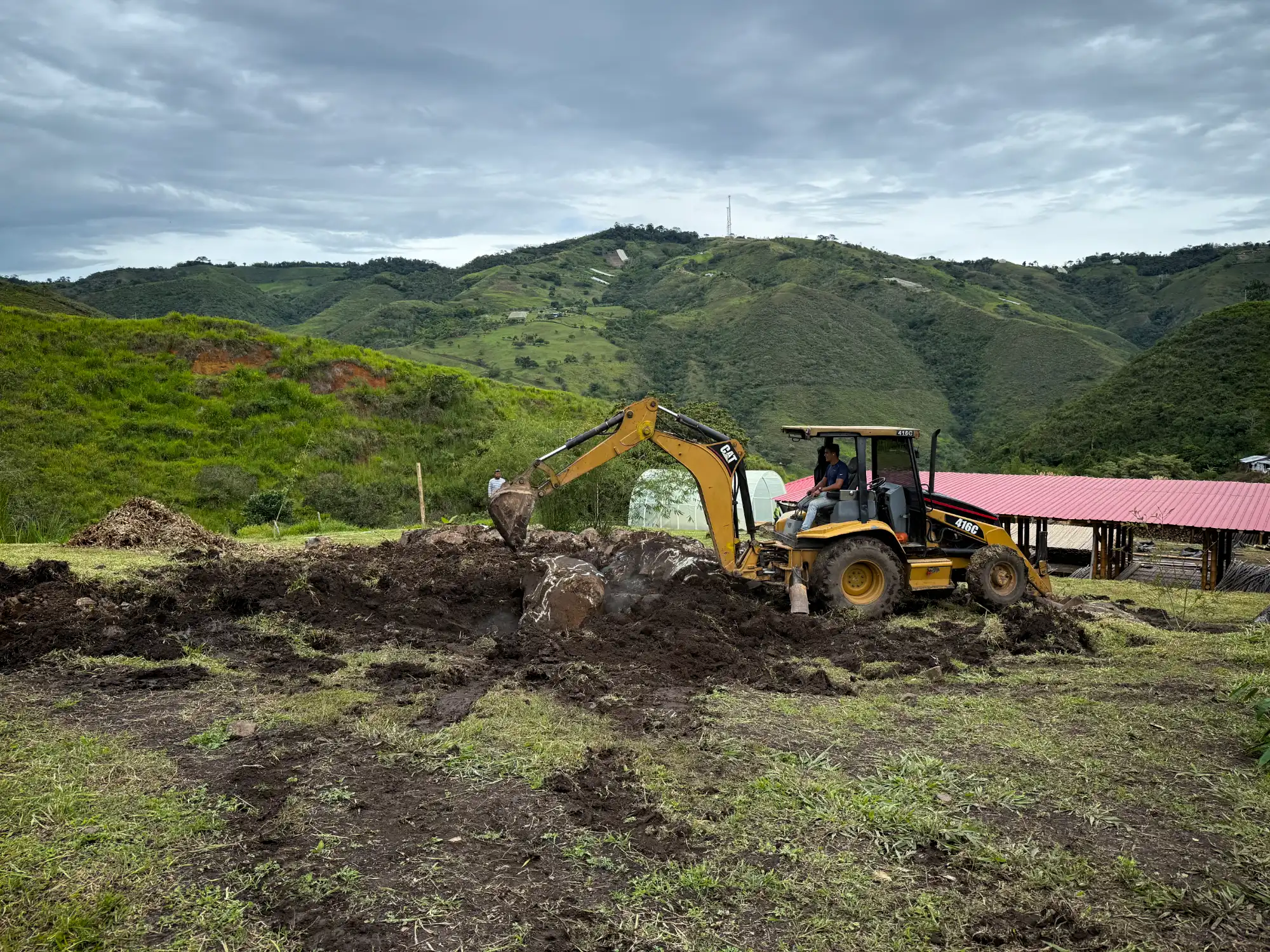 Excavation with backhoe for bamboo pavilion foundation