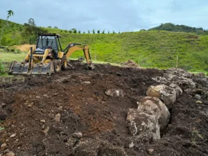 Excavation with backhoe for bamboo pavilion foundation