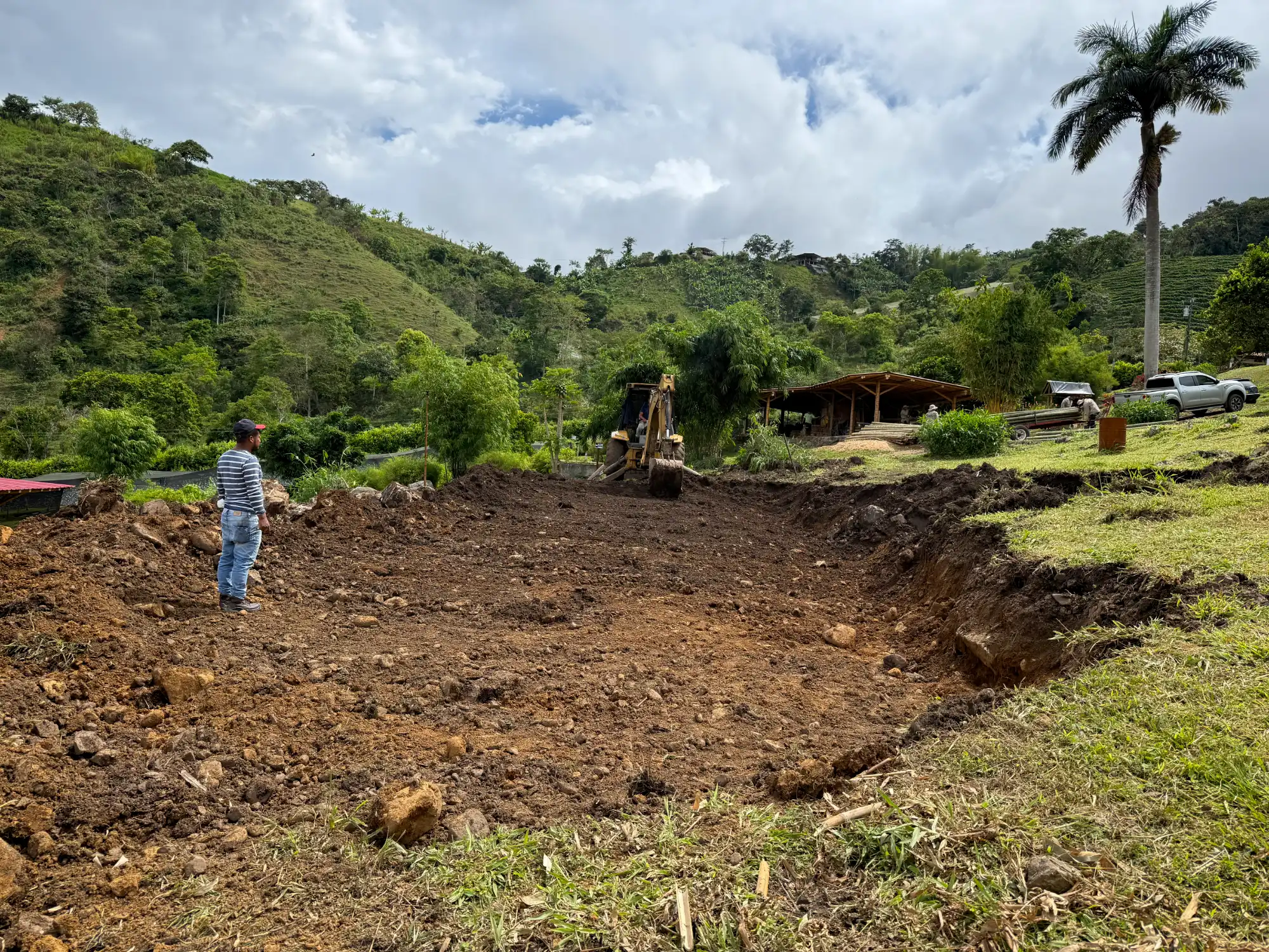 Excavation with backhoe for bamboo pavilion foundation