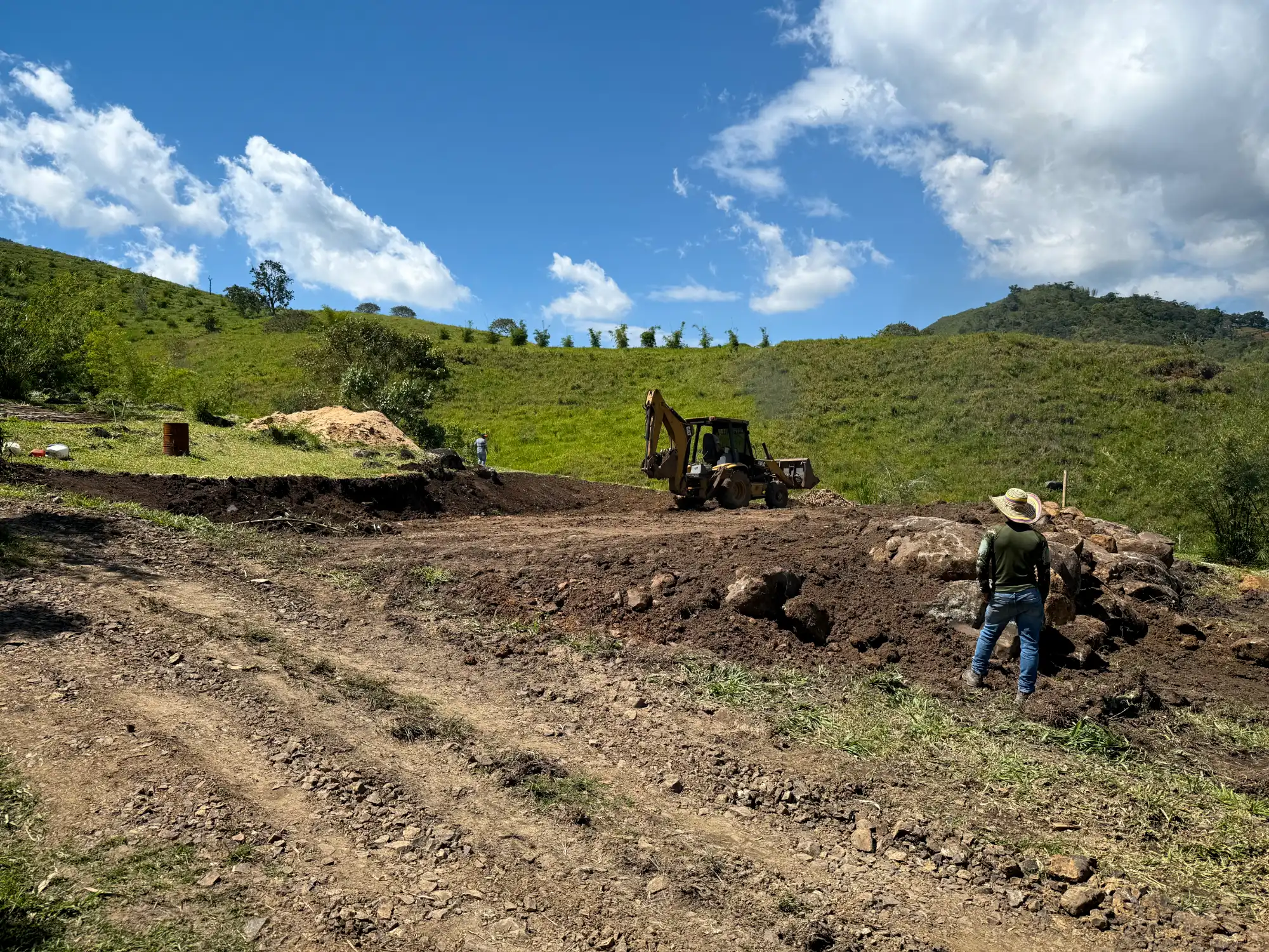 Excavation with backhoe for bamboo pavilion foundation