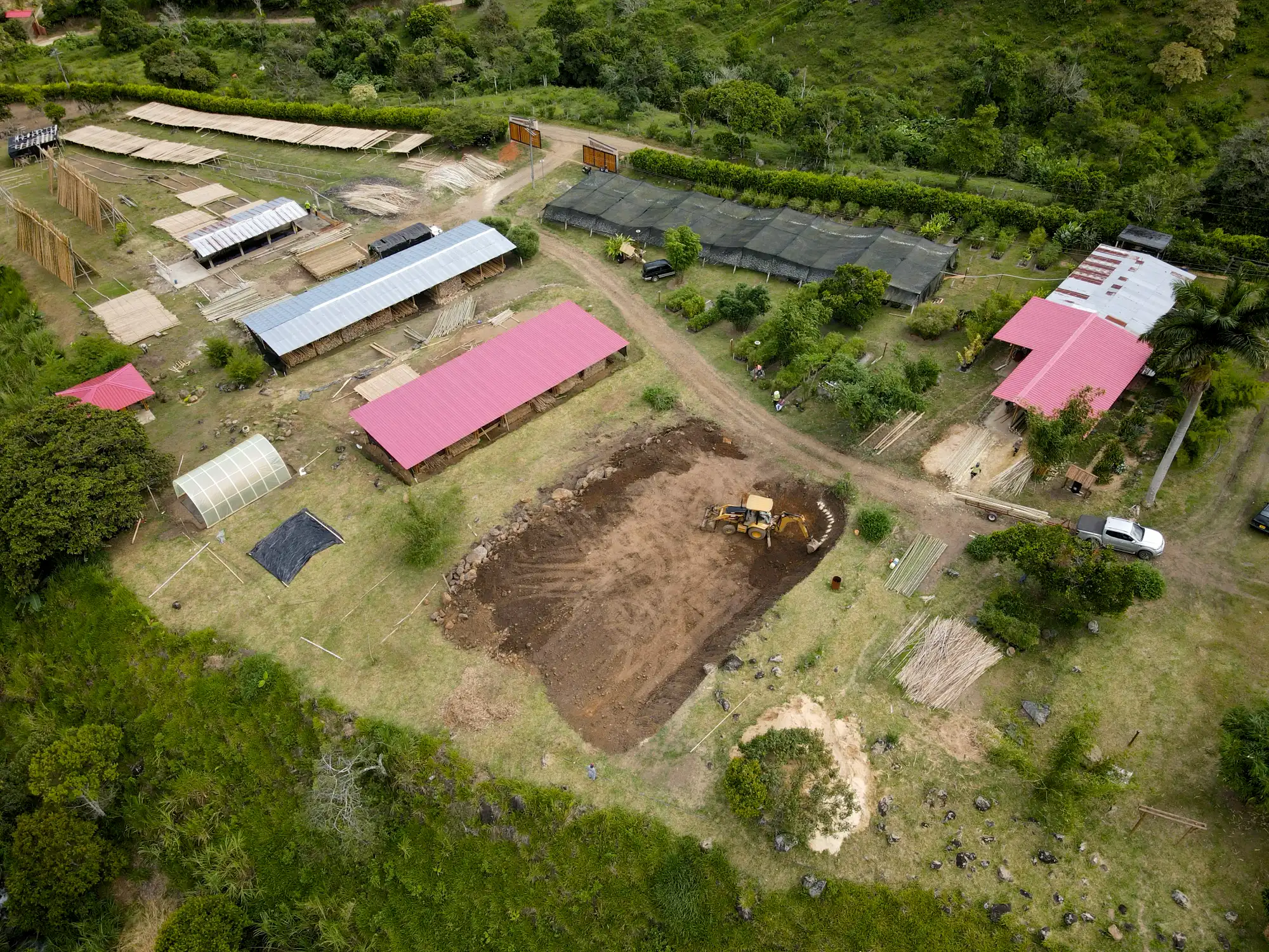 Excavation with backhoe for bamboo pavilion foundation