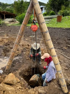 River stone extraction using bamboo tripod and pulley