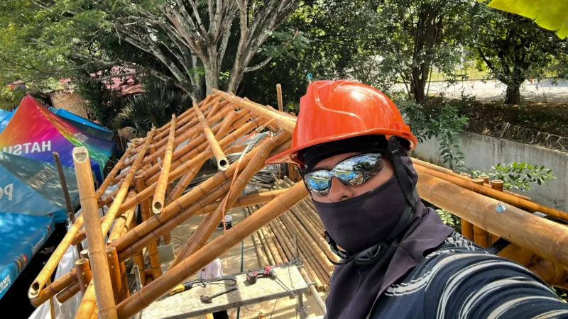 Installing the Guadua bamboo roof rafters and bracing over the prefabricated structure