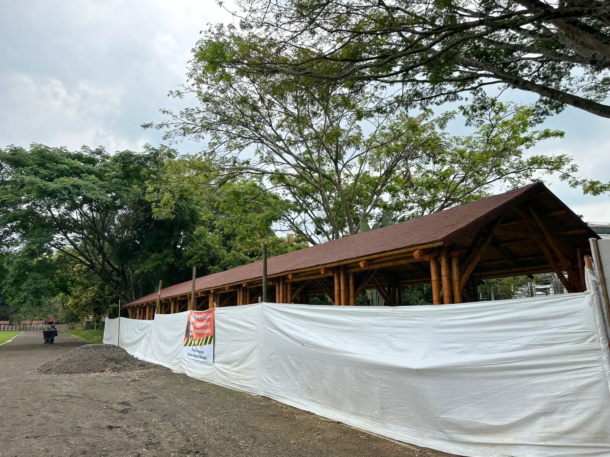 Installing asphalt roof shingles over the prefabricated bamboo structure